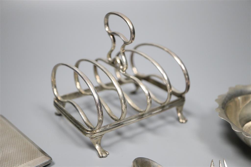 An early 20th century silver toastrack, a silver bowl, silver cigarette case and minor flatware including silver and plated.